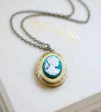 Load image into Gallery viewer, Teal Ivory Cameo Oval Locket Necklace. Antiqued Brass Locket Lady Face Profile Silhouette Picture Photo Locket Necklace
